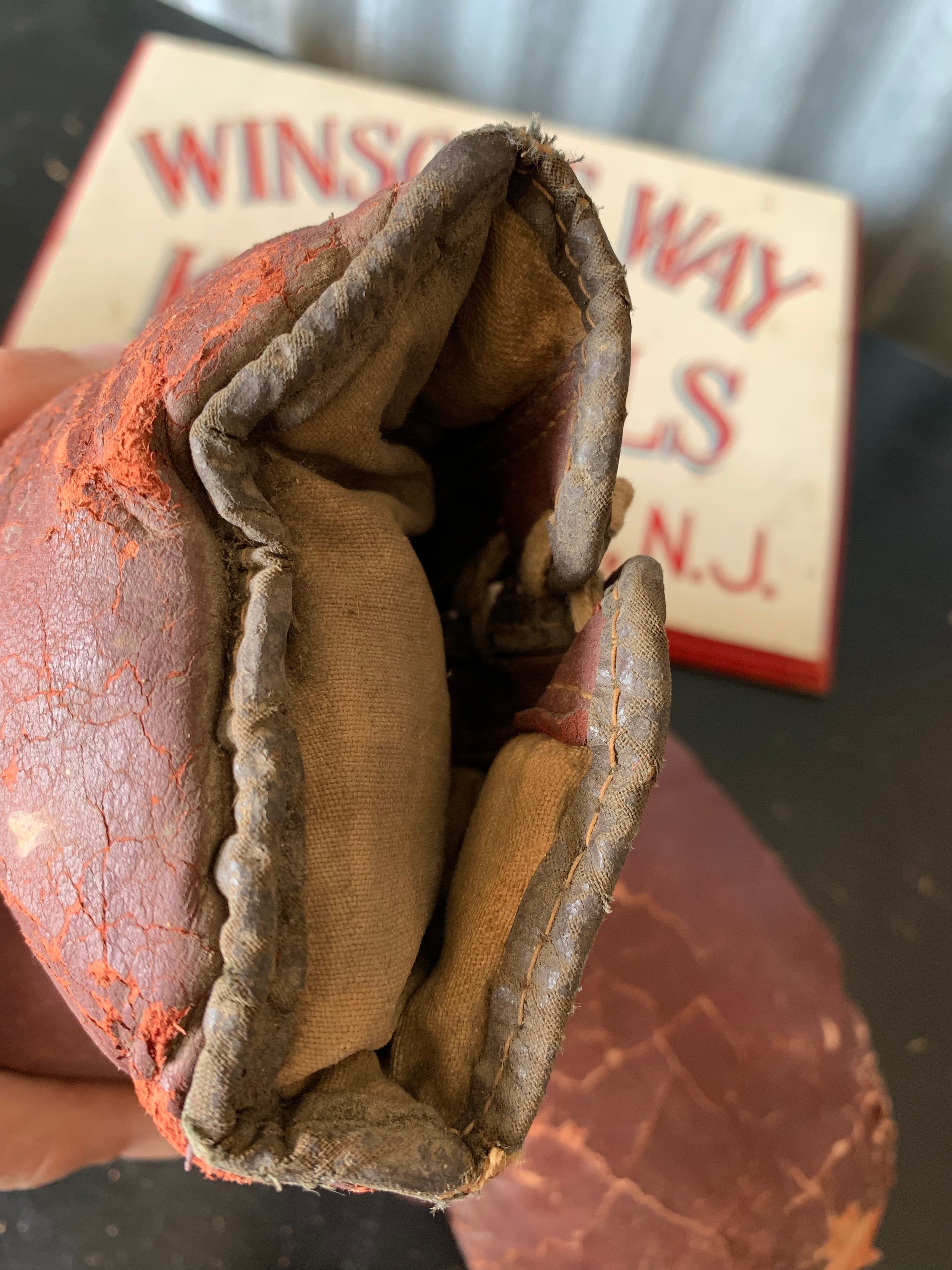 A vintage pair of large red leather boxing gloves