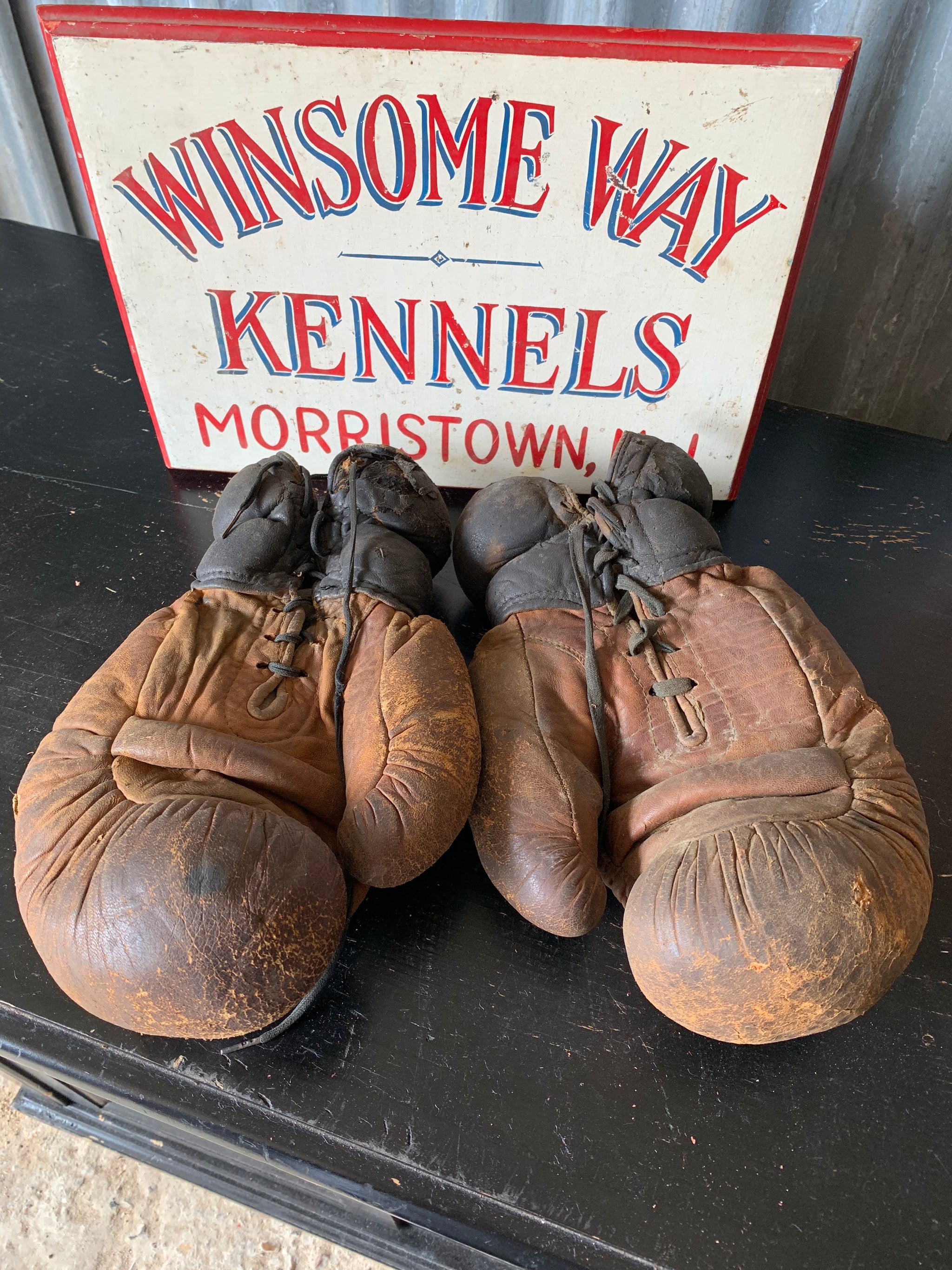 A vintage pair of large brown leather boxing gloves