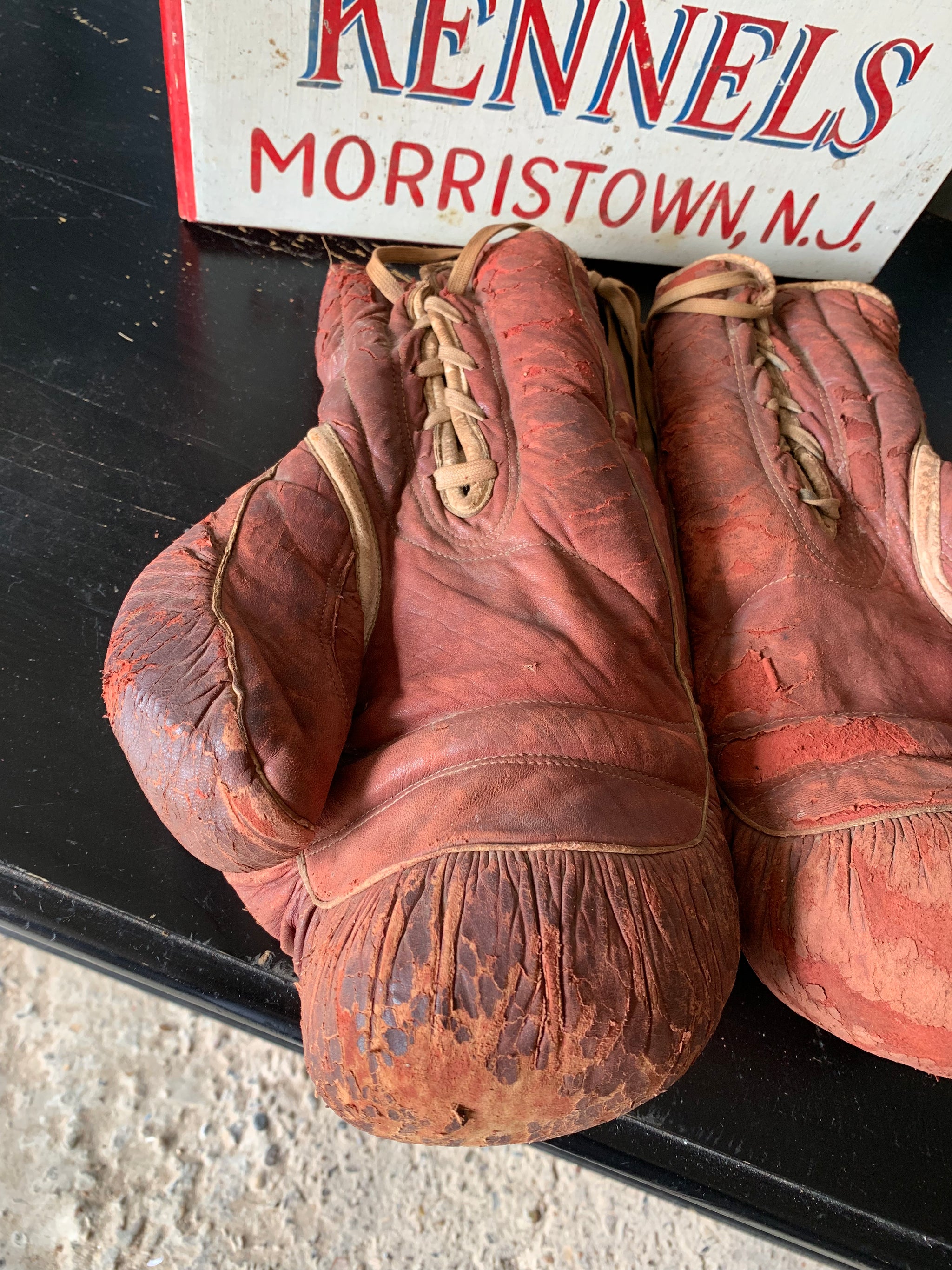 A vintage pair of large red leather Everlast boxing gloves