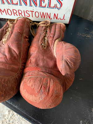 A vintage pair of large red leather Everlast boxing gloves