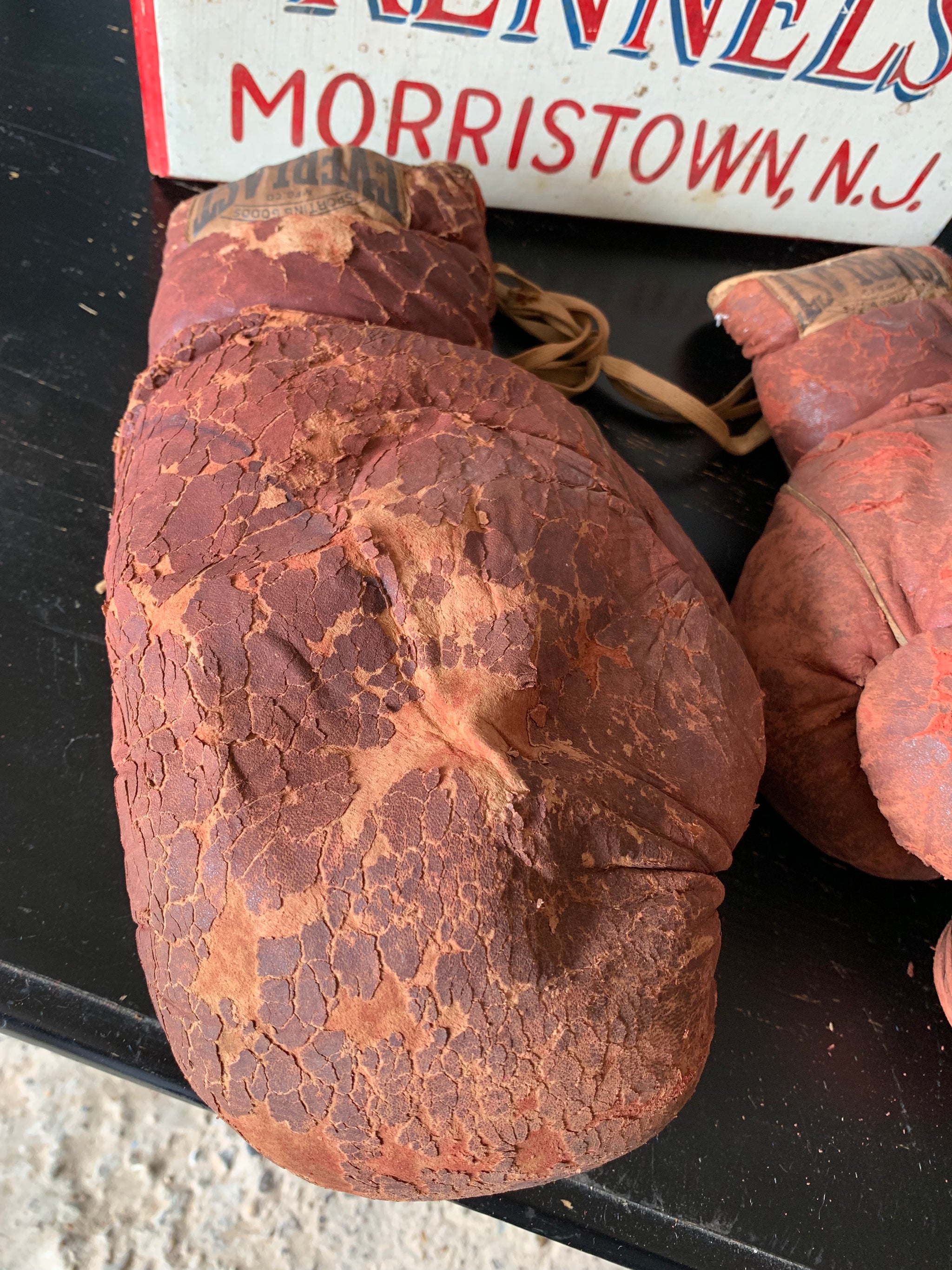 A vintage pair of large red leather Everlast boxing gloves