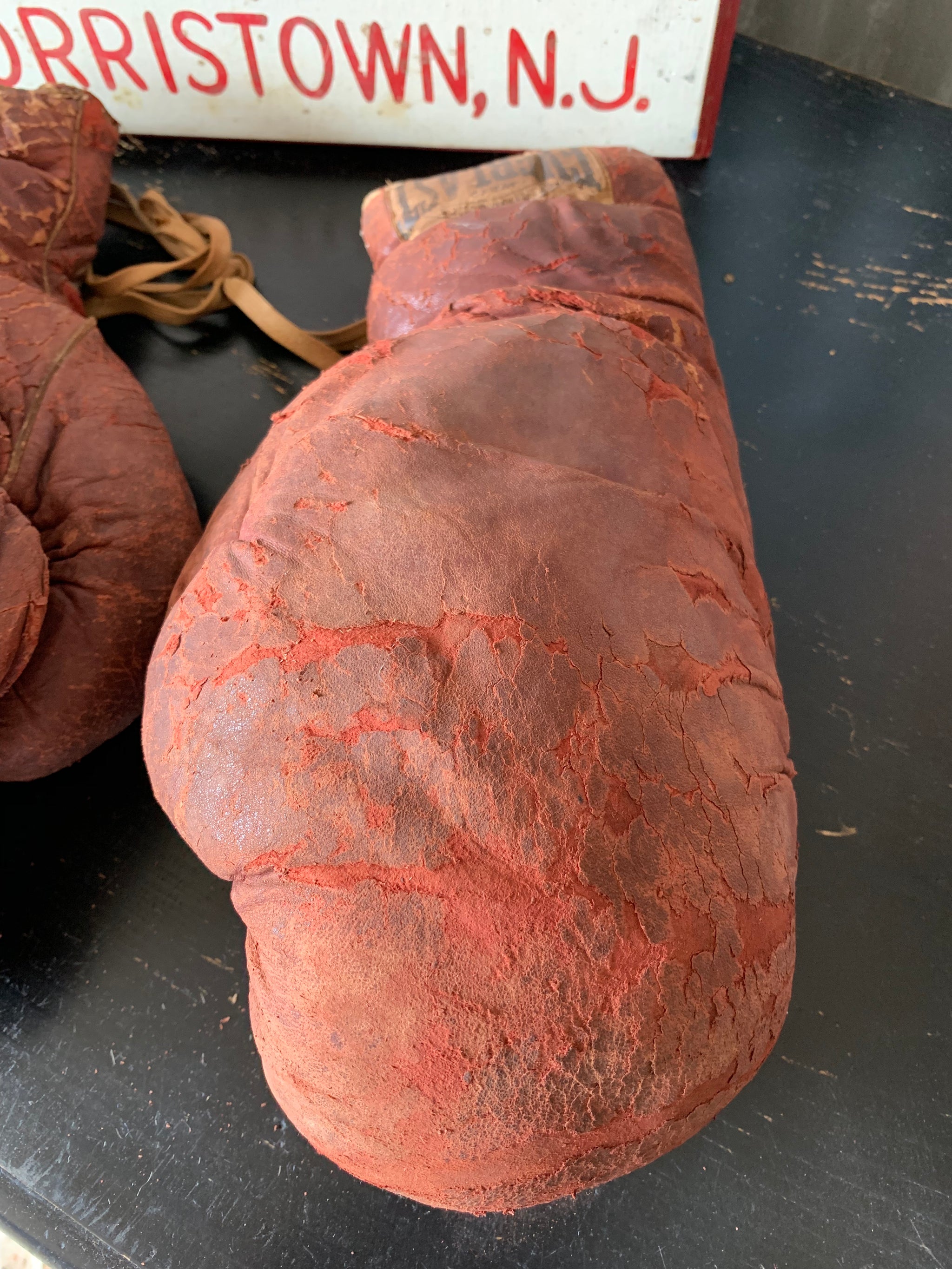 A vintage pair of large red leather Everlast boxing gloves