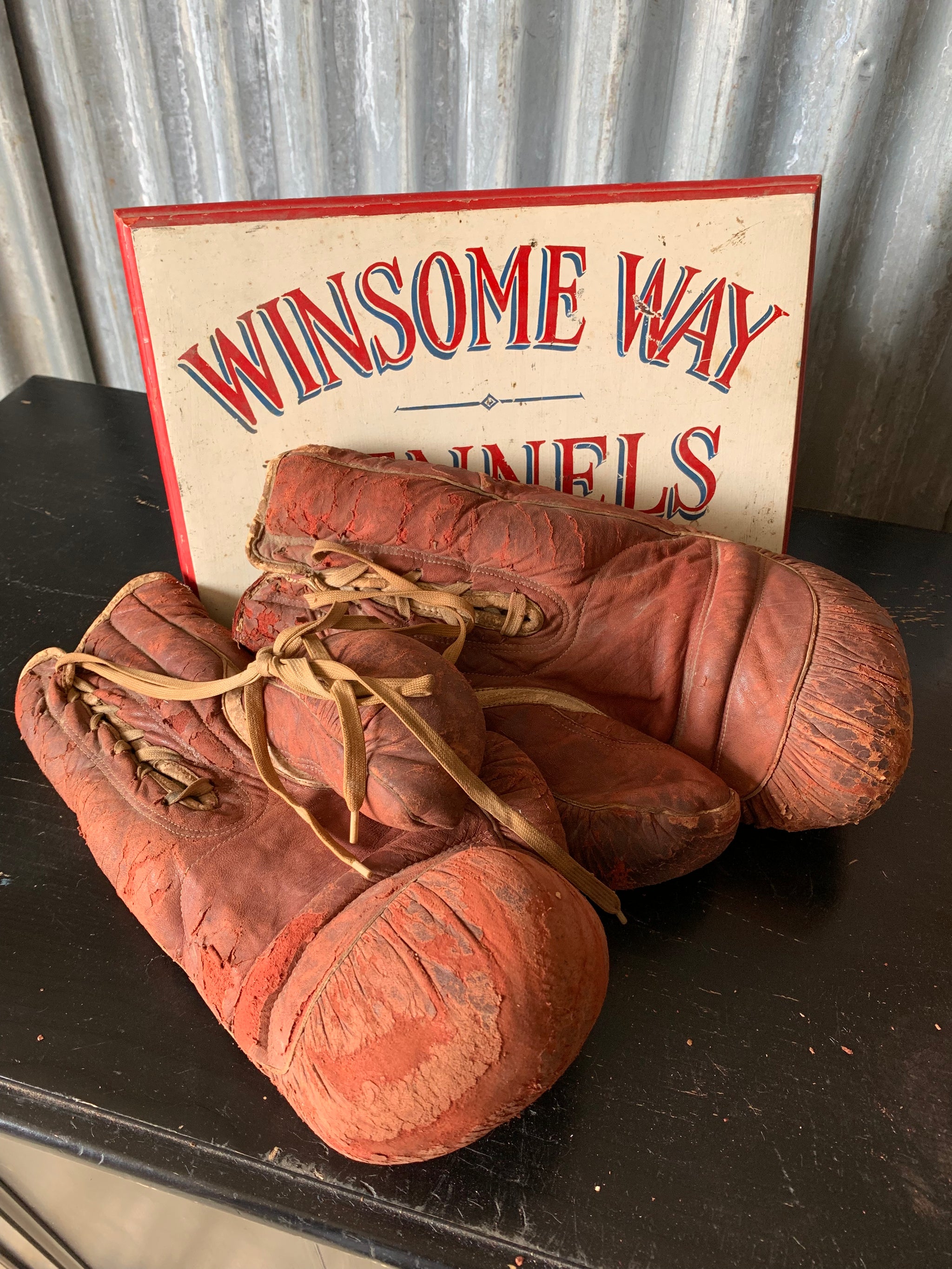 A vintage pair of large red leather Everlast boxing gloves