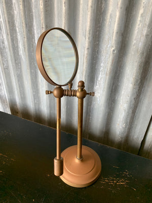 A vintage magnifying glass on a stand