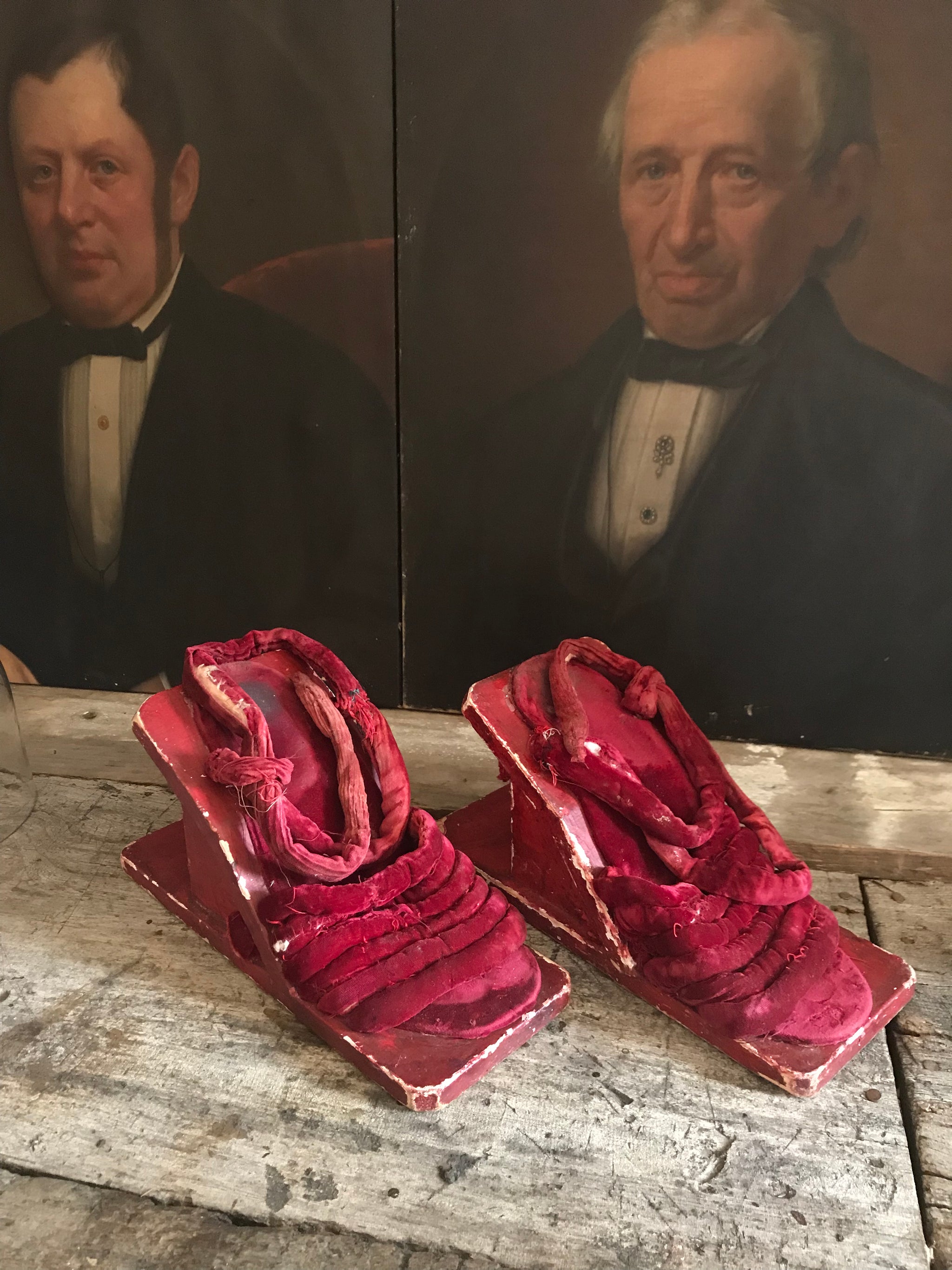 A pair of red velvet wood and gesso geisha block sandals