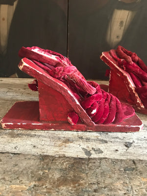 A pair of red velvet wood and gesso geisha block sandals