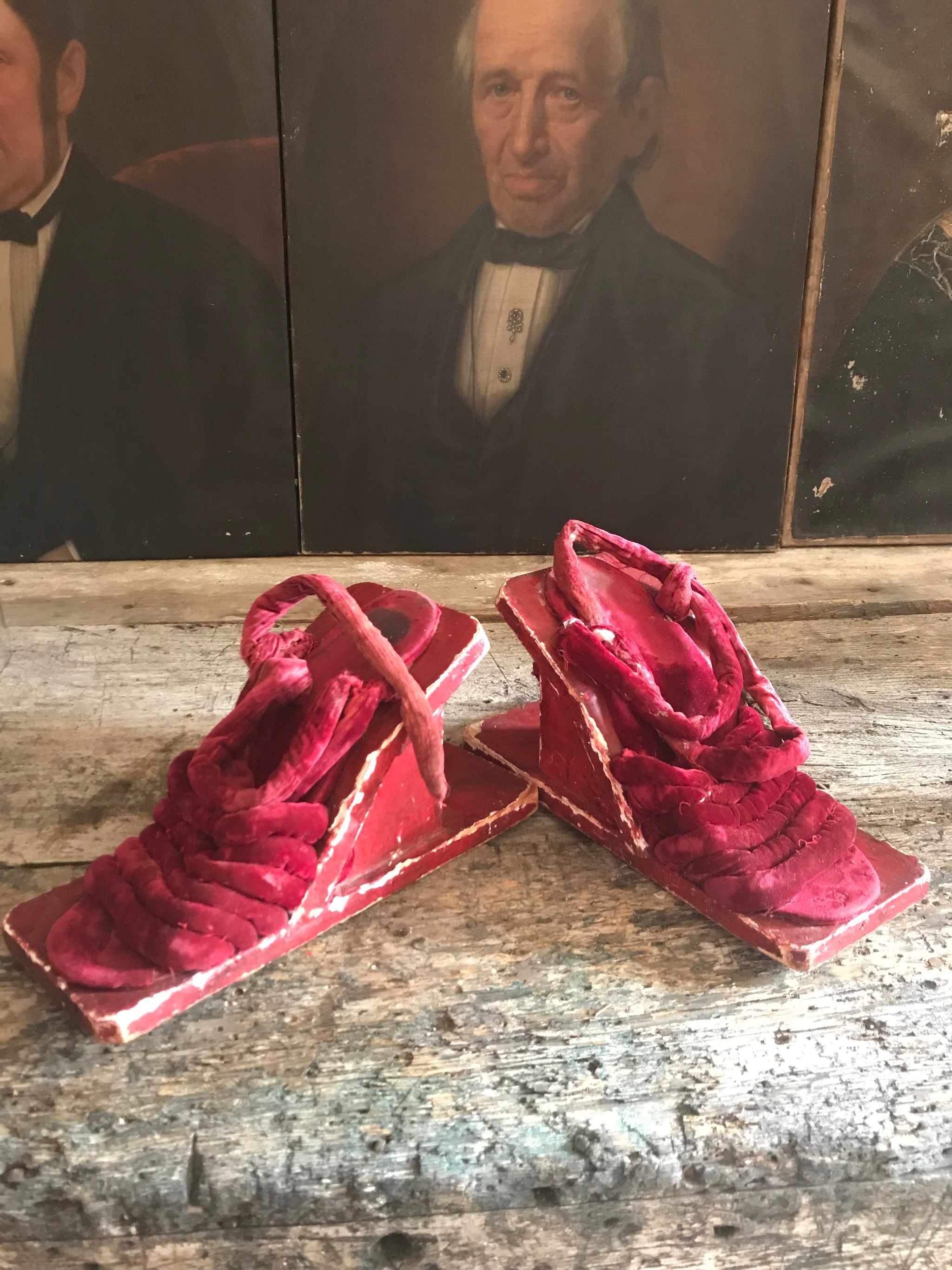 A pair of red velvet wood and gesso geisha block sandals