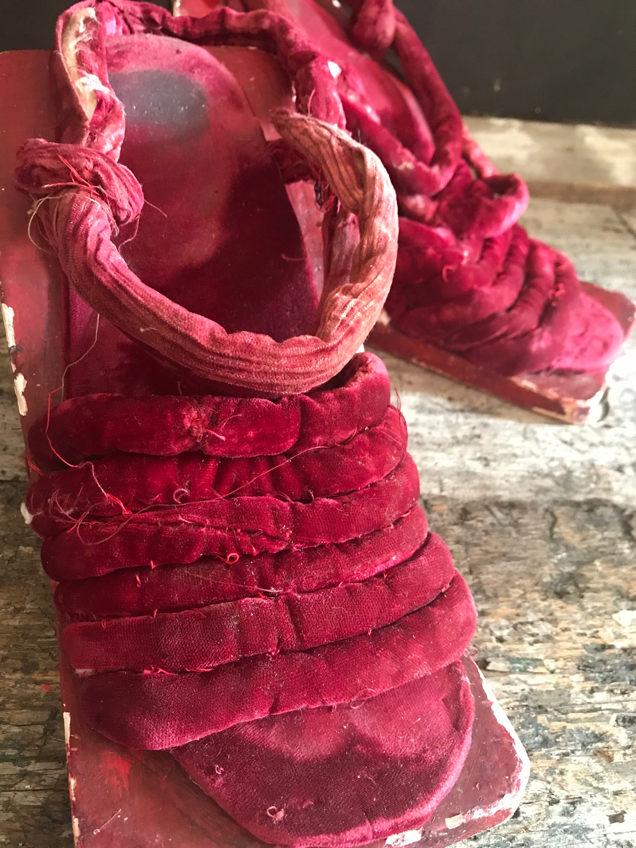 A pair of red velvet wood and gesso geisha block sandals