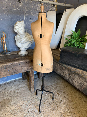 A Chil-Daw female mannequin dress form with cast iron base
