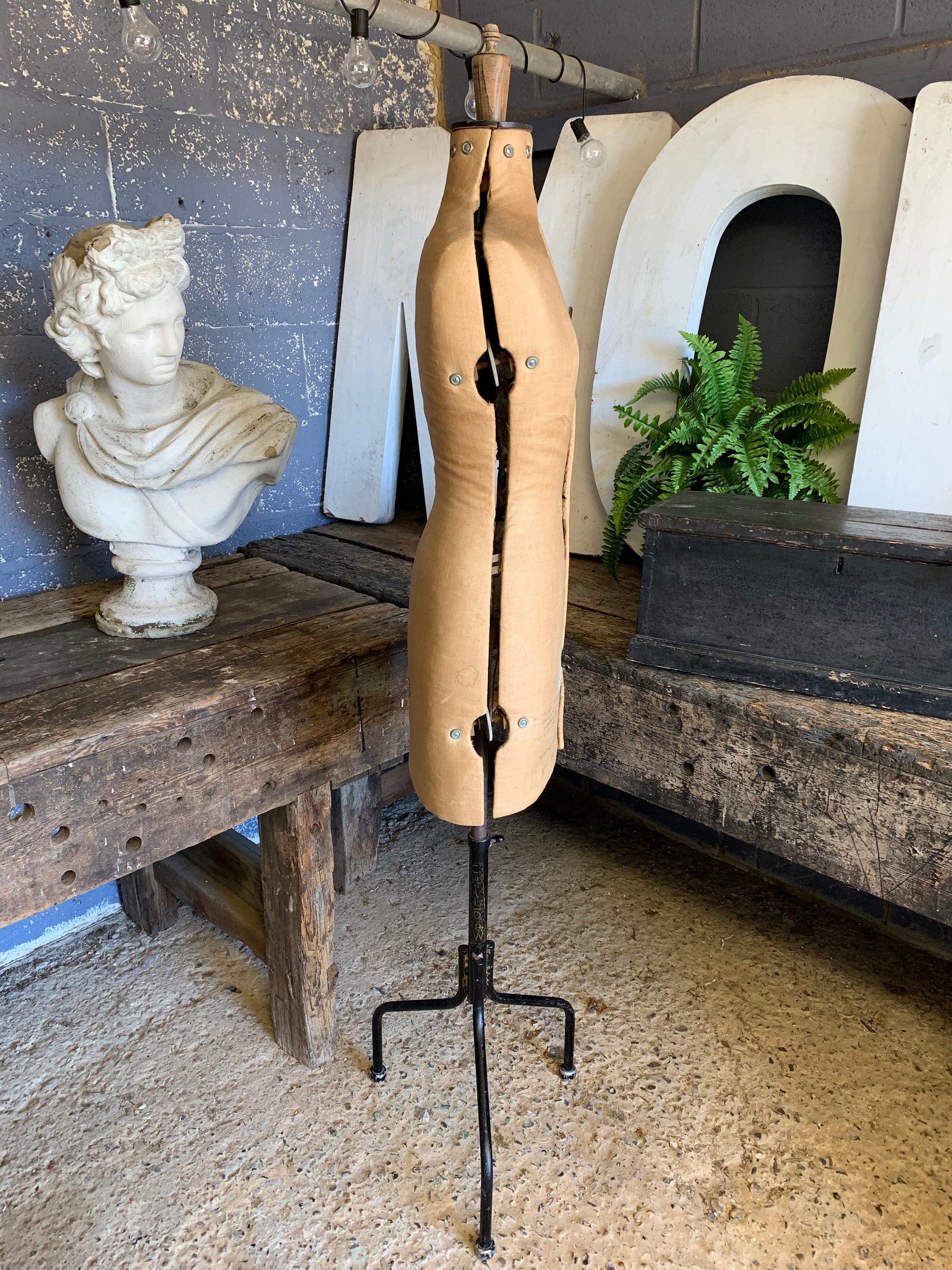 A Chil-Daw female mannequin dress form with cast iron base