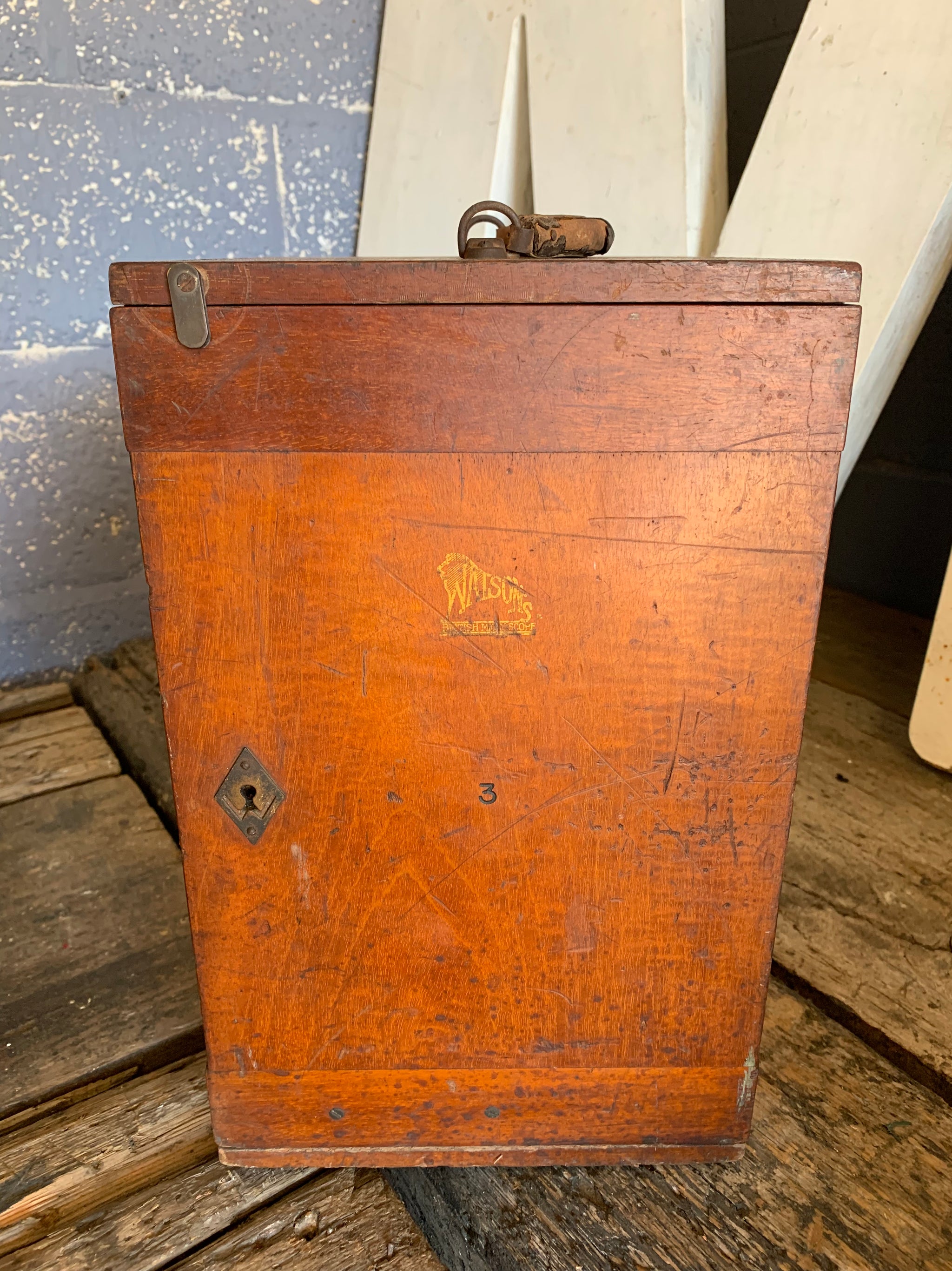 A Watson Service brass monocular microscope in original wooden case