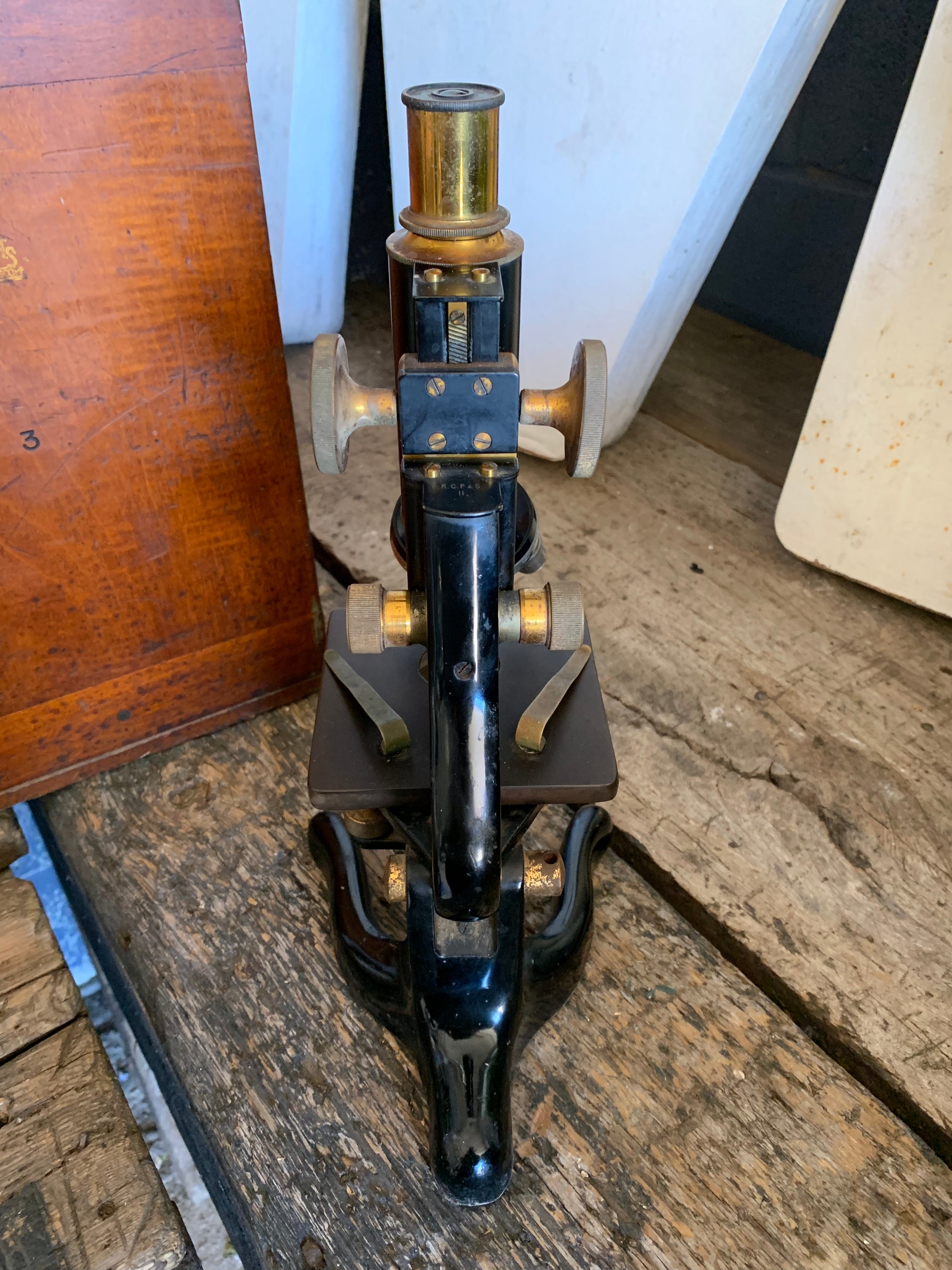 A Watson Service brass monocular microscope in original wooden case