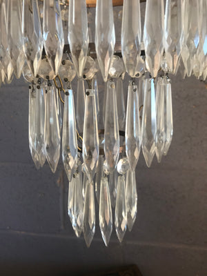 A gilt three tier crystal icicle droplet chandelier