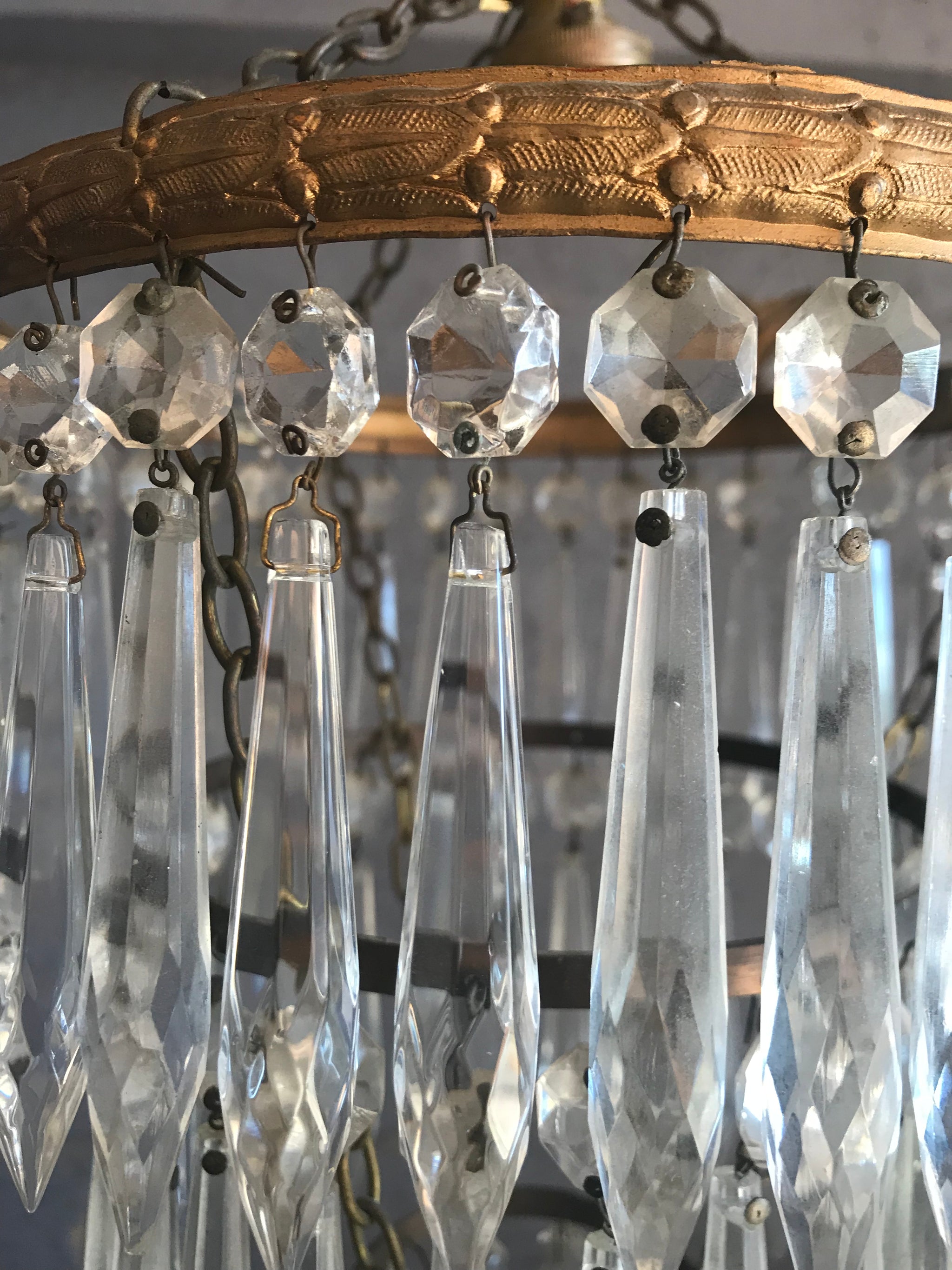 A gilt three tier crystal icicle droplet chandelier