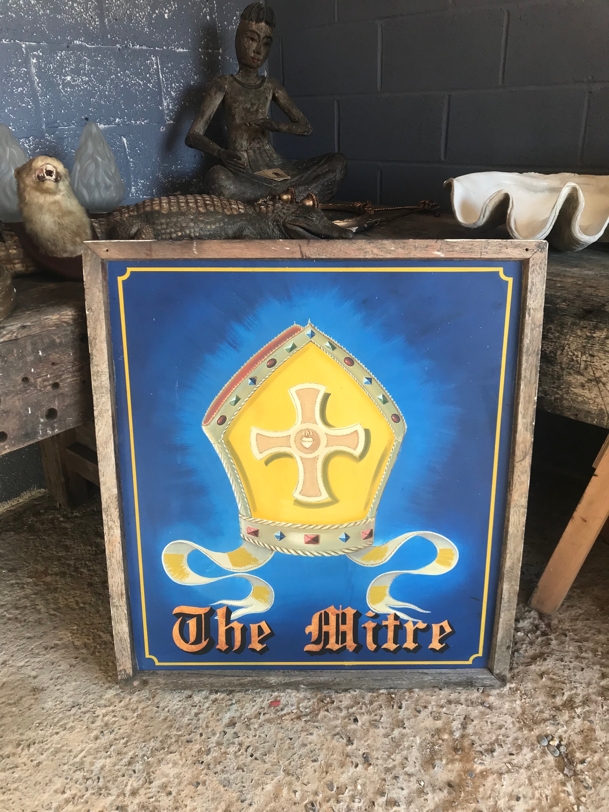 A wooden double-sided hand-painted pub sign