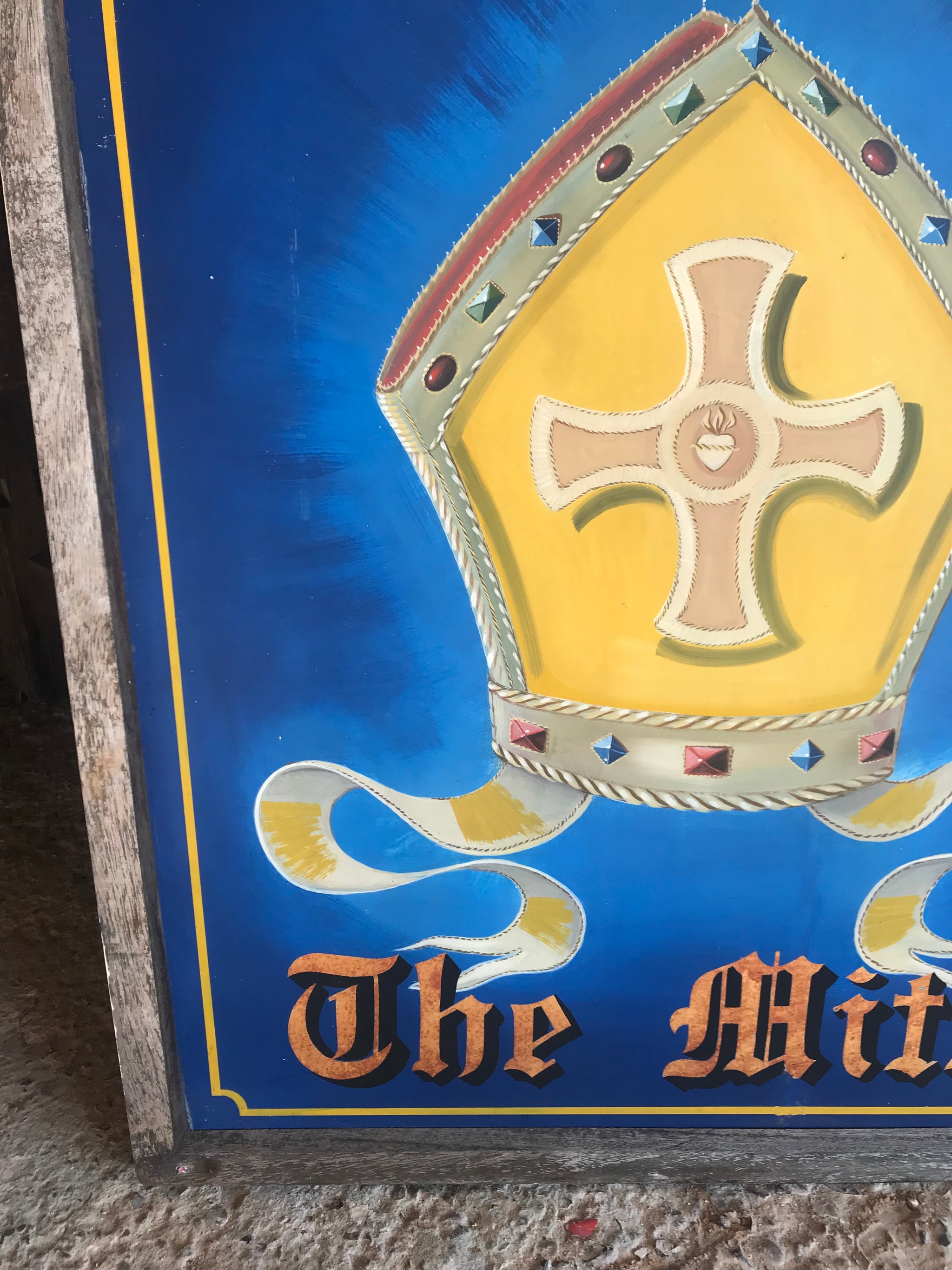 A wooden double-sided hand-painted pub sign