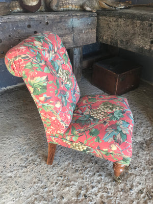 A 'country house' button back nursing chair with brass castors