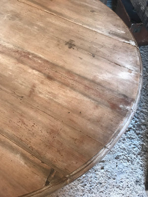 A drop leaf circular bleached pine painted table on castors