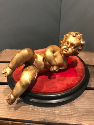 A Large Gilt Wood and Gesso Carved Putto