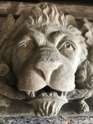 A stone relief plaque of an heraldic lion with oak branch and acorns