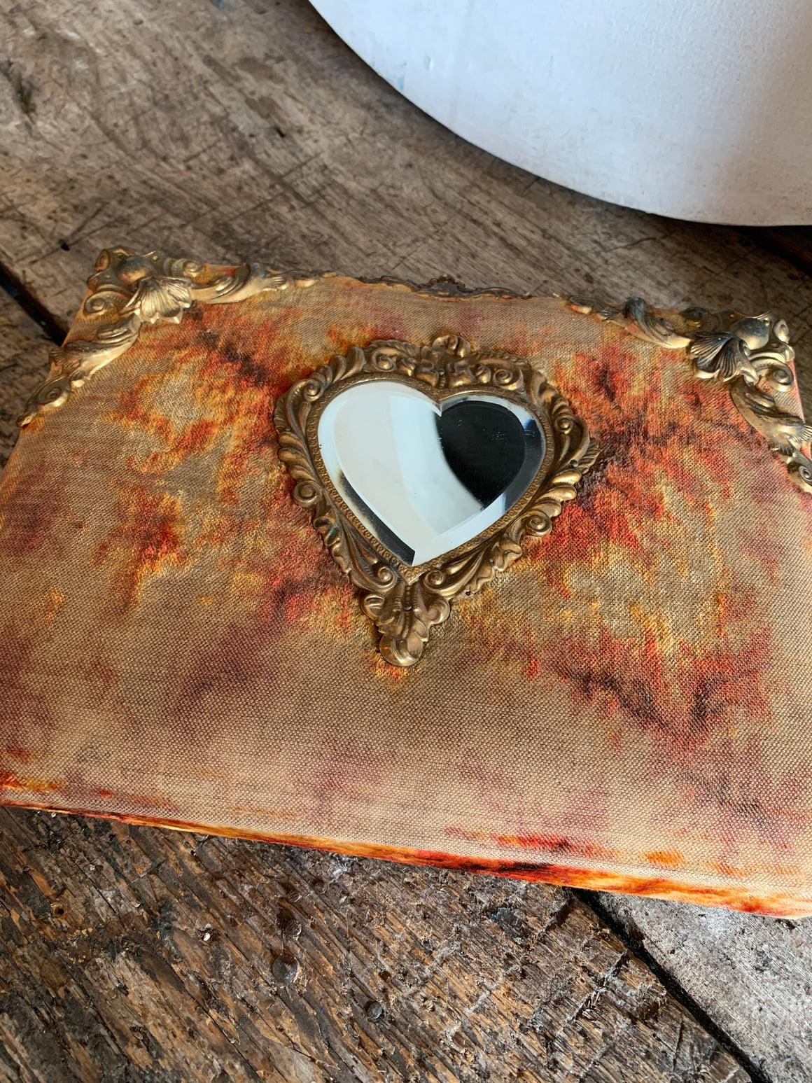A Victorian cartes de visite photo album with velvet cover and heart-shaped mirror insert