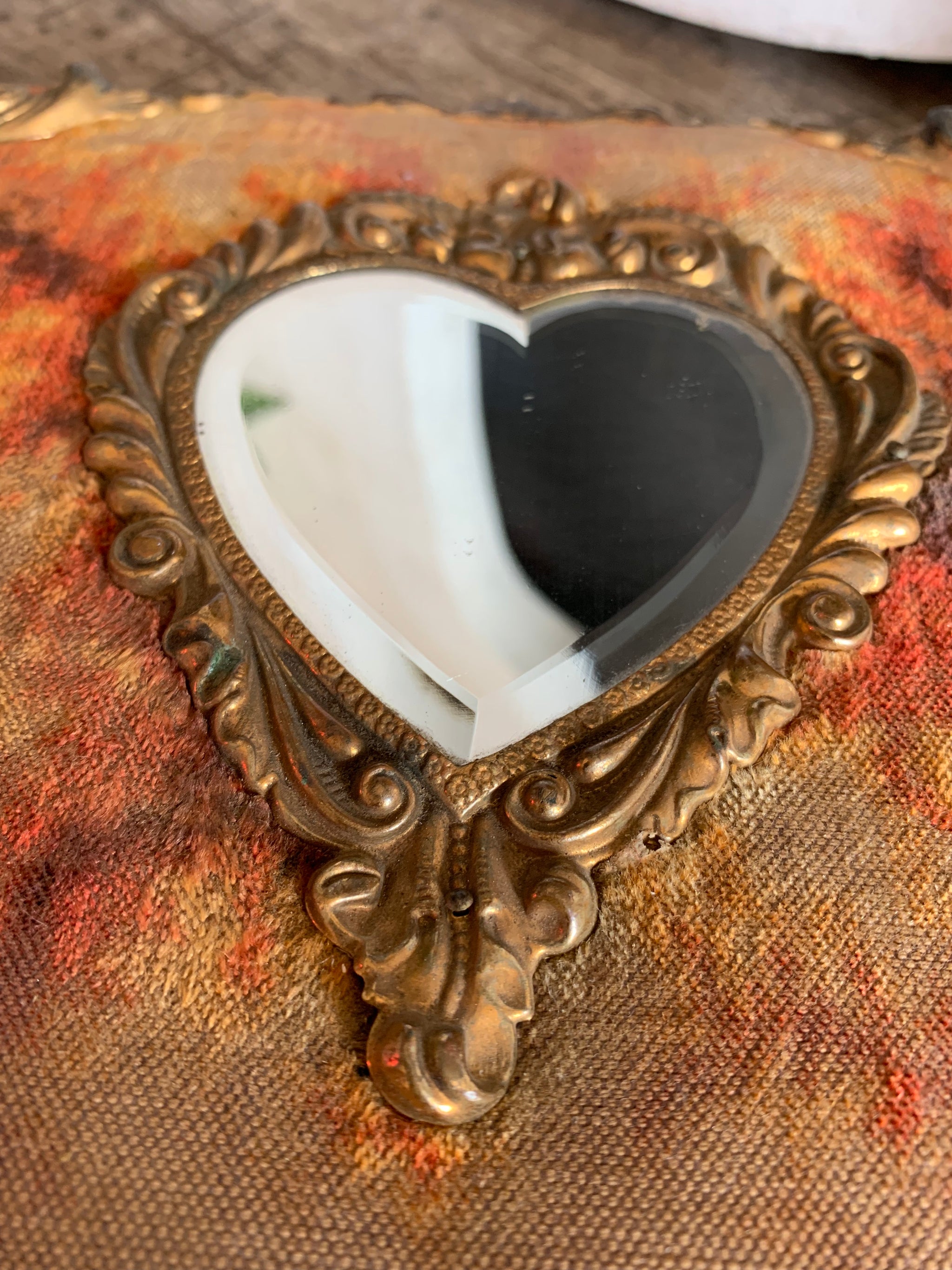 A Victorian cartes de visite photo album with velvet cover and heart-shaped mirror insert