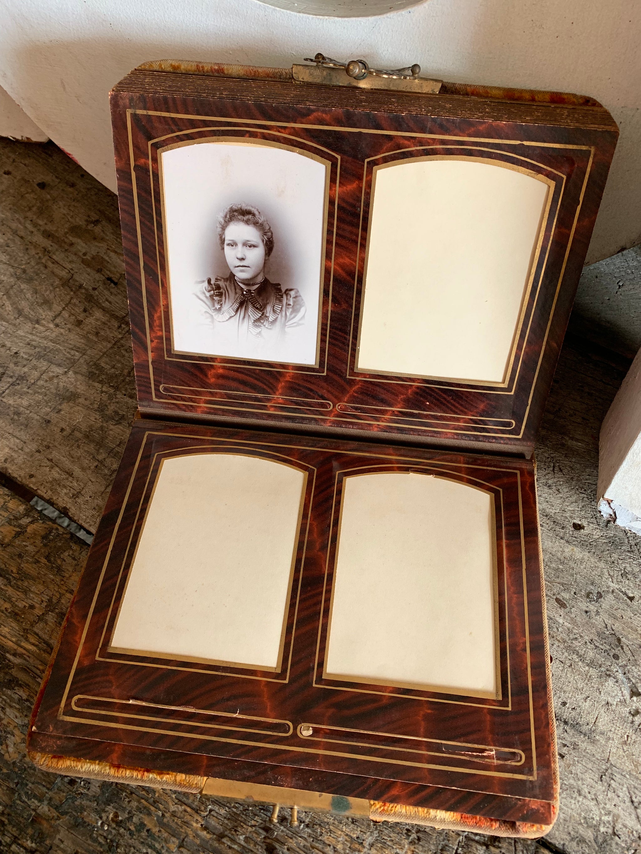 A Victorian cartes de visite photo album with velvet cover and heart-shaped mirror insert
