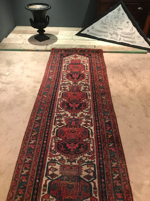 A red ground wool Persian runner rug- 295cm x 95cm