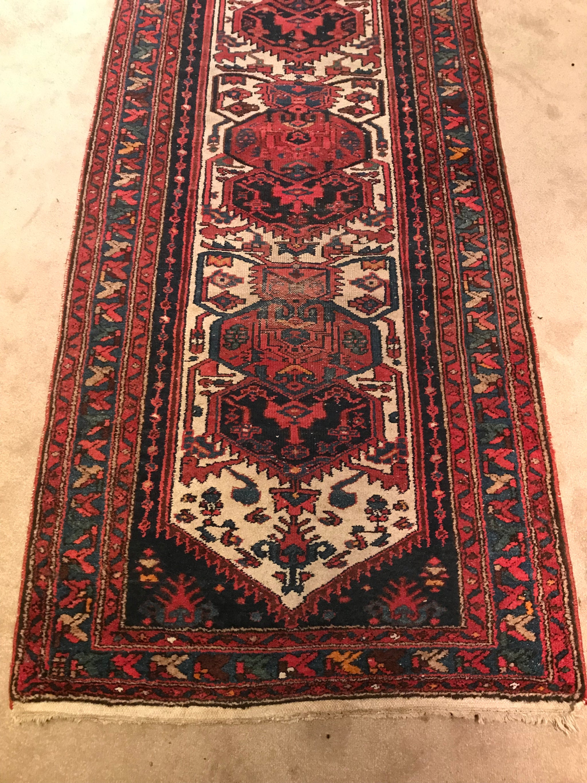 A red ground wool Persian runner rug- 295cm x 95cm