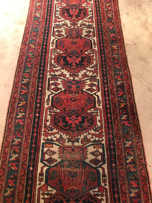 A red ground wool Persian runner rug- 295cm x 95cm
