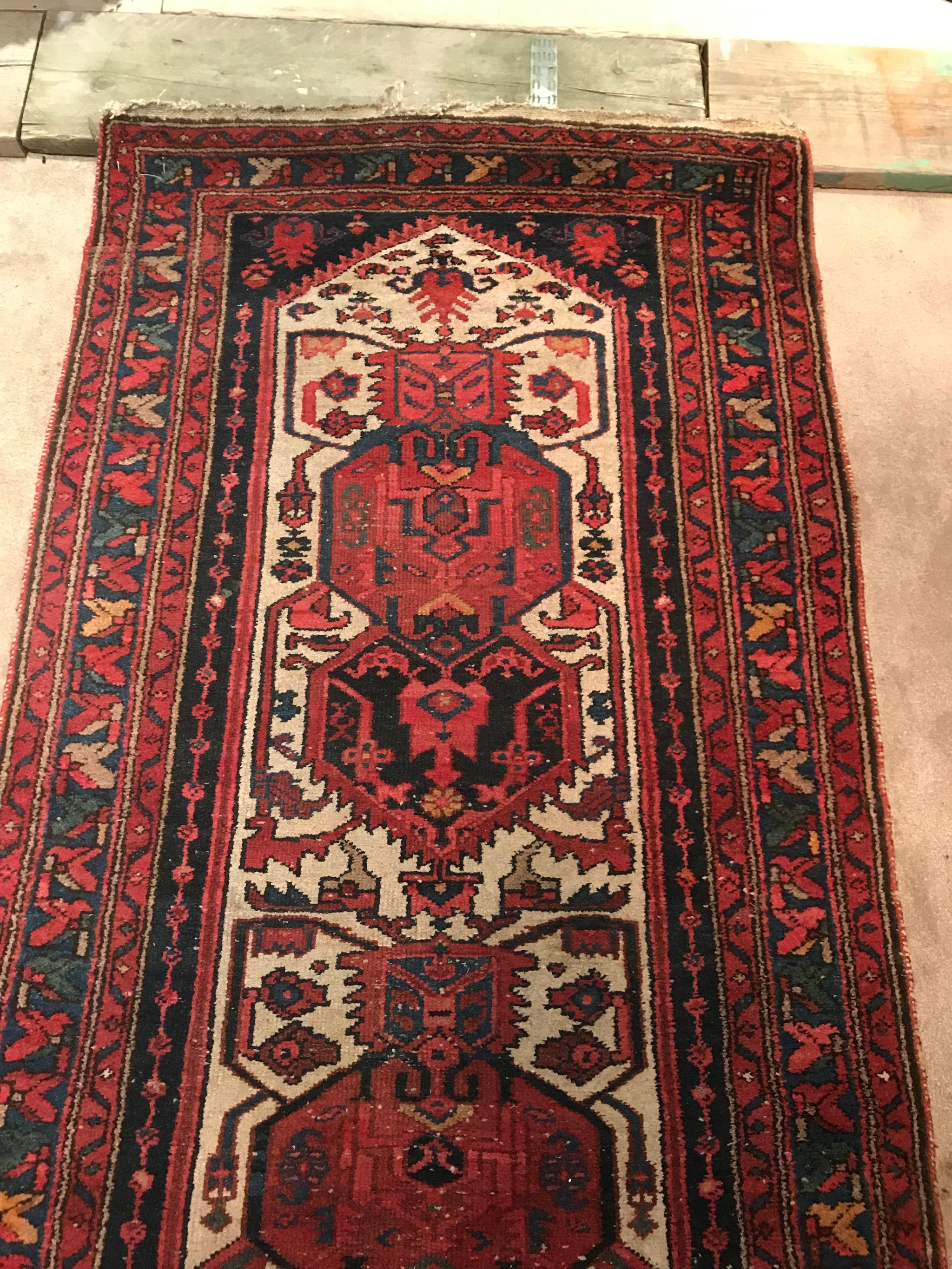A red ground wool Persian runner rug- 295cm x 95cm