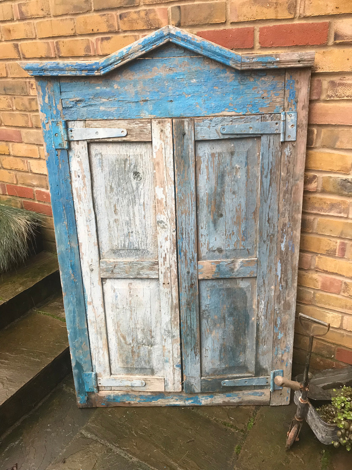 A salvaged blue door or window