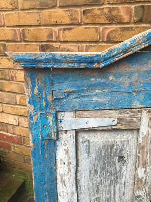 A salvaged blue door or window