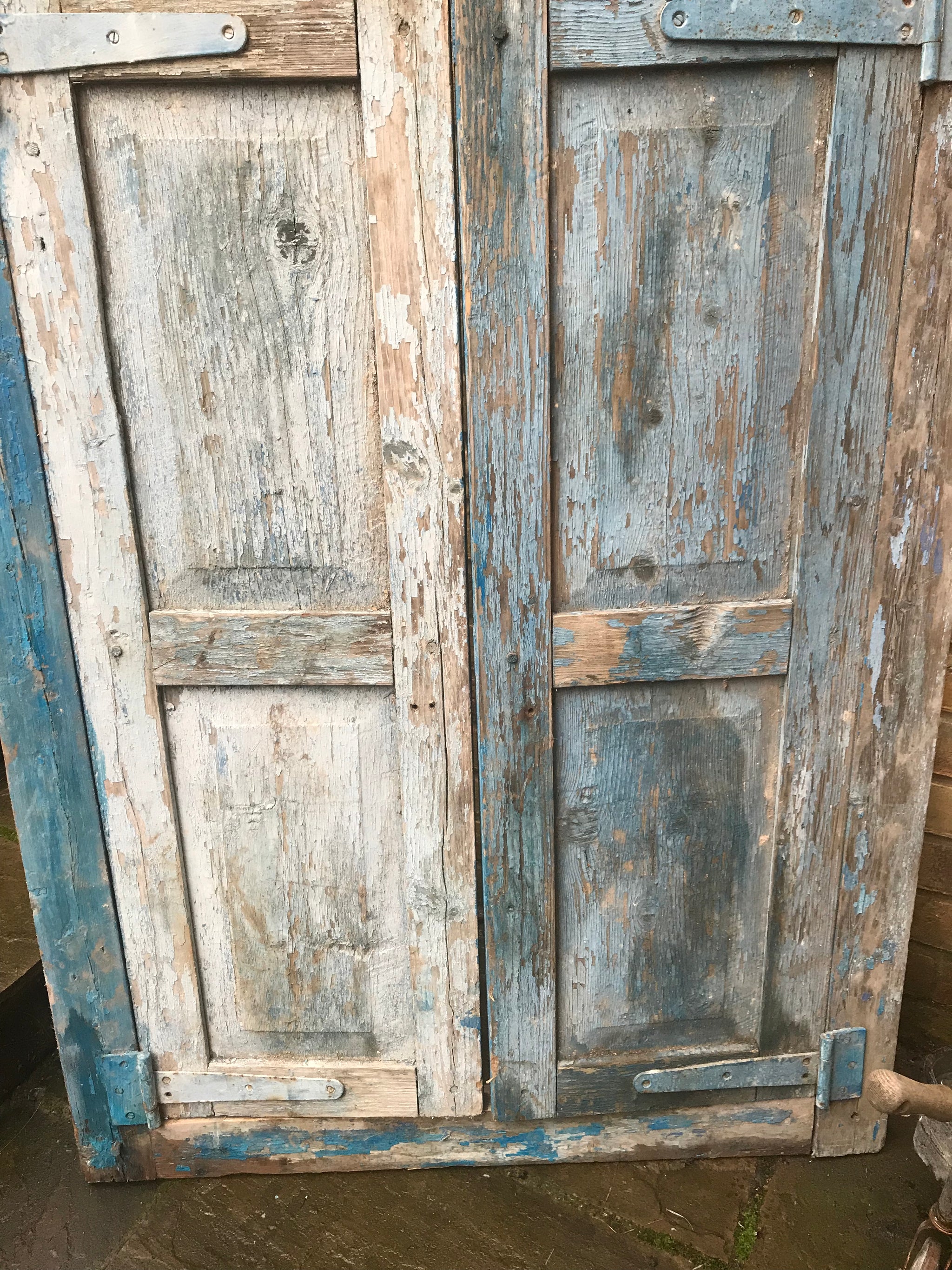 A salvaged blue door or window
