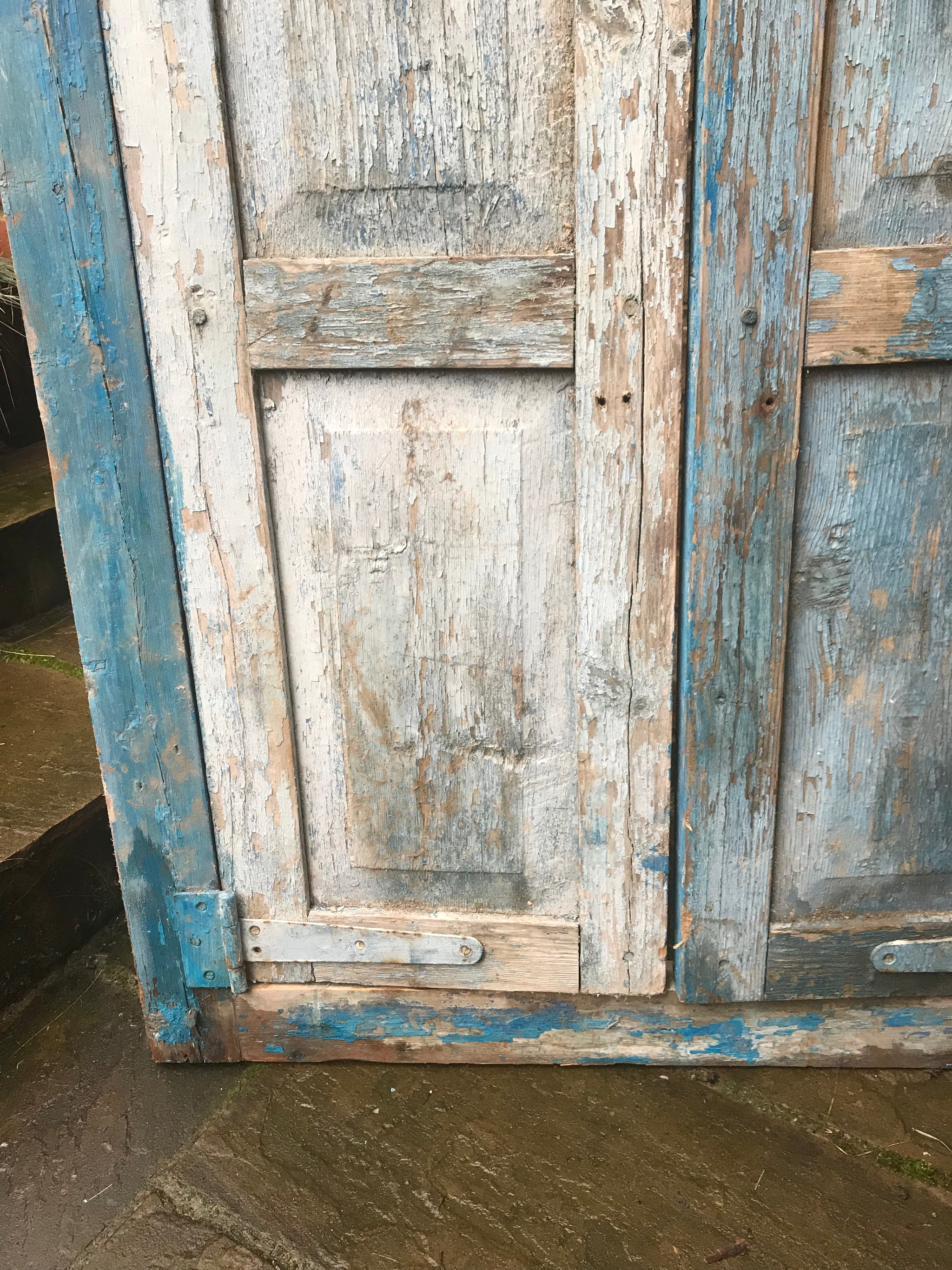 A salvaged blue door or window