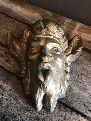 A gold face mask of the satyr Pan