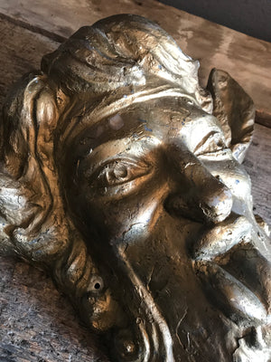 A gold face mask of the satyr Pan