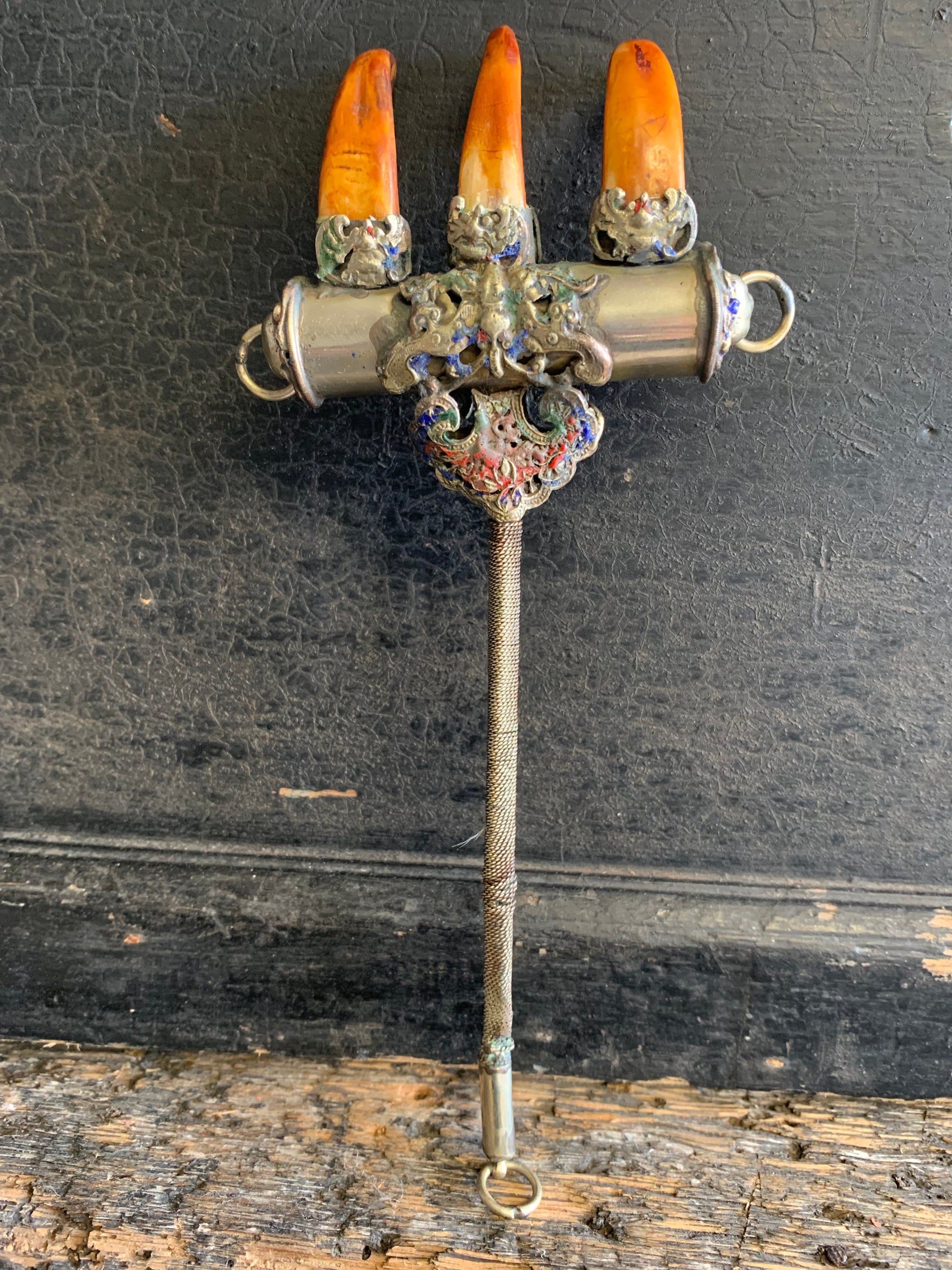 An enamelled Tibetan sliver claw back scratcher with bat and lion motifs