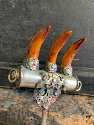 An enamelled Tibetan sliver claw back scratcher with bat and lion motifs
