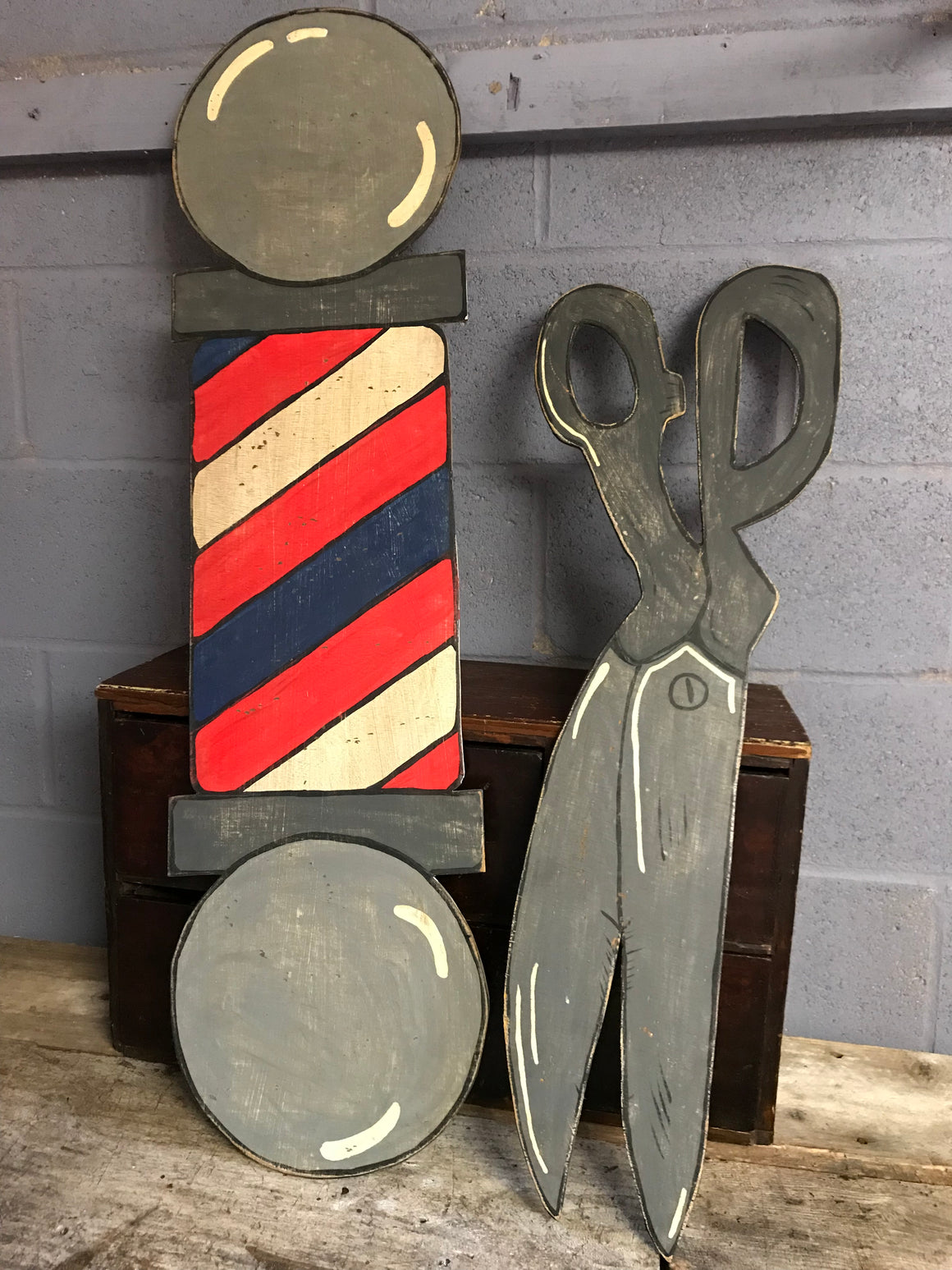 A hand painted barber's pole cut out advertising panel