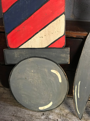 A hand painted barber's pole cut out advertising panel