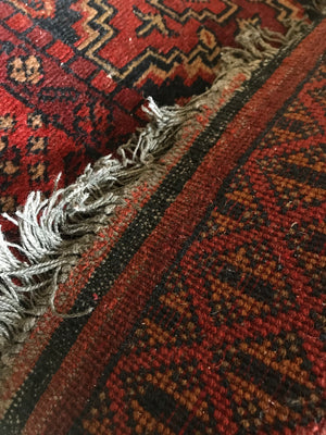 A short red ground Persian runner rug