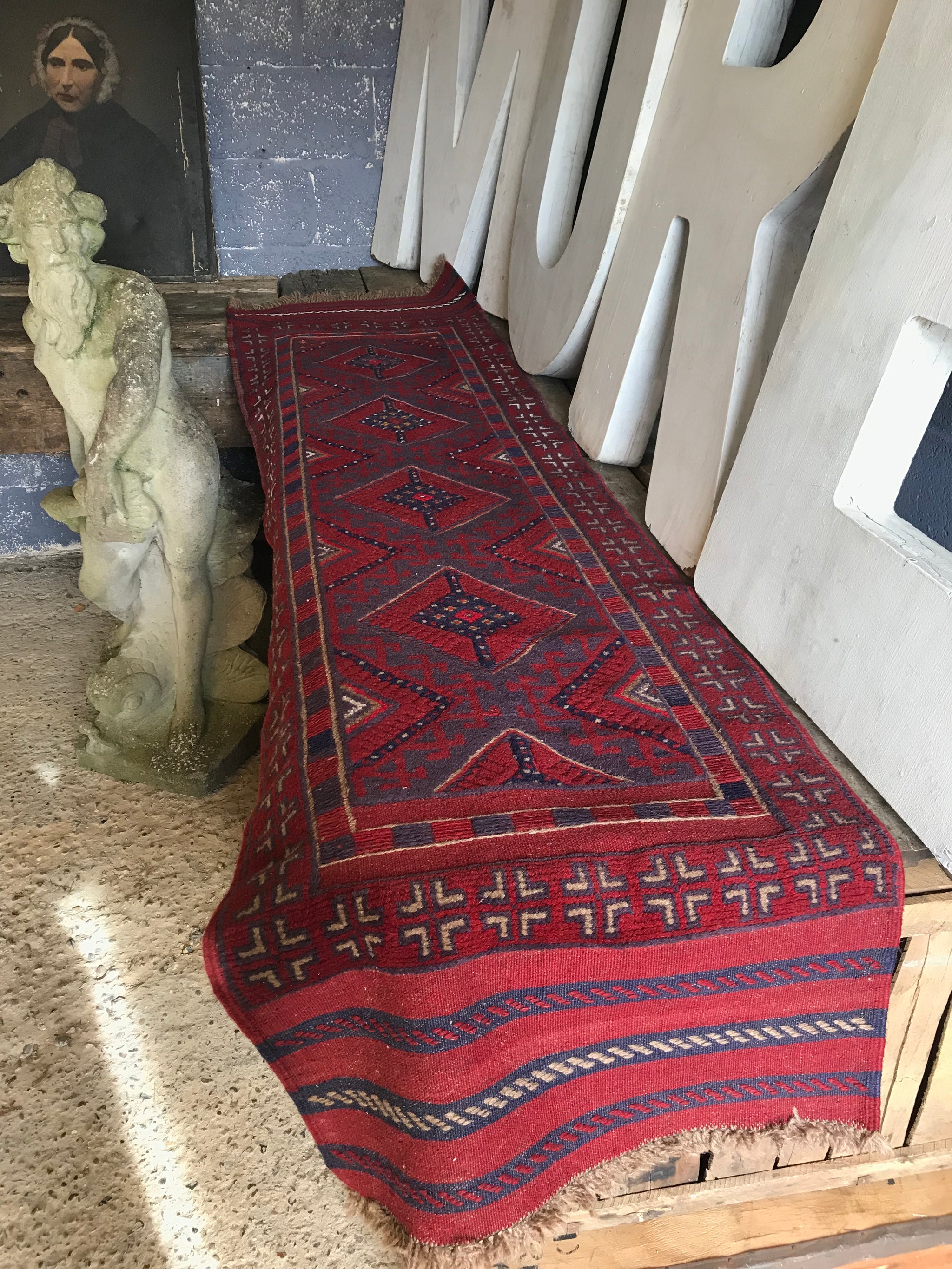 A long red ground Persian runner rug