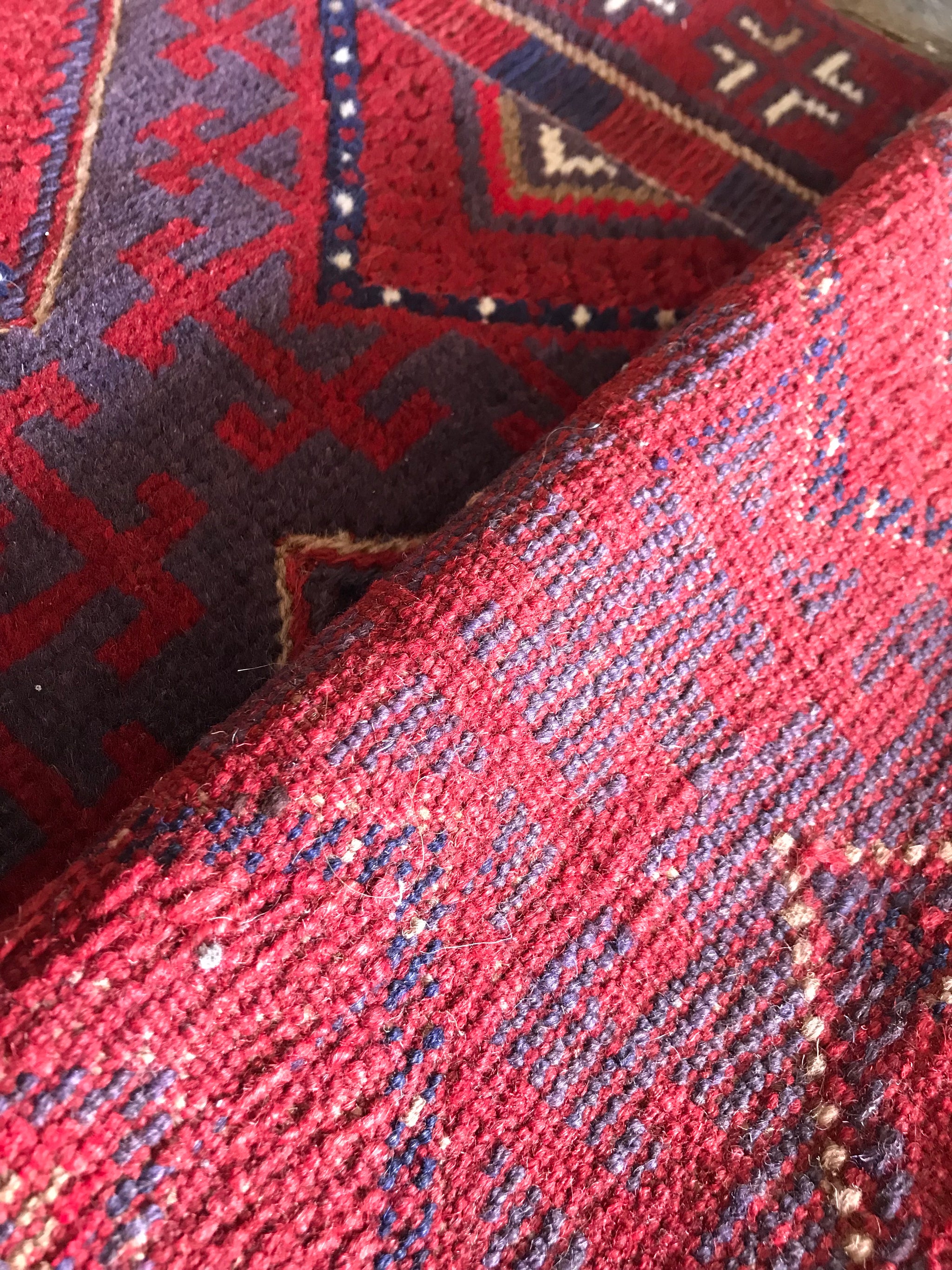 A long red ground Persian runner rug