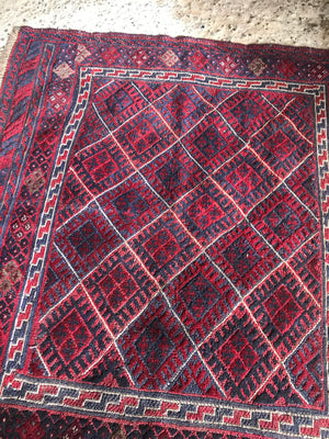 A square red ground Persian rug