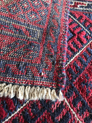 A square red ground Persian rug