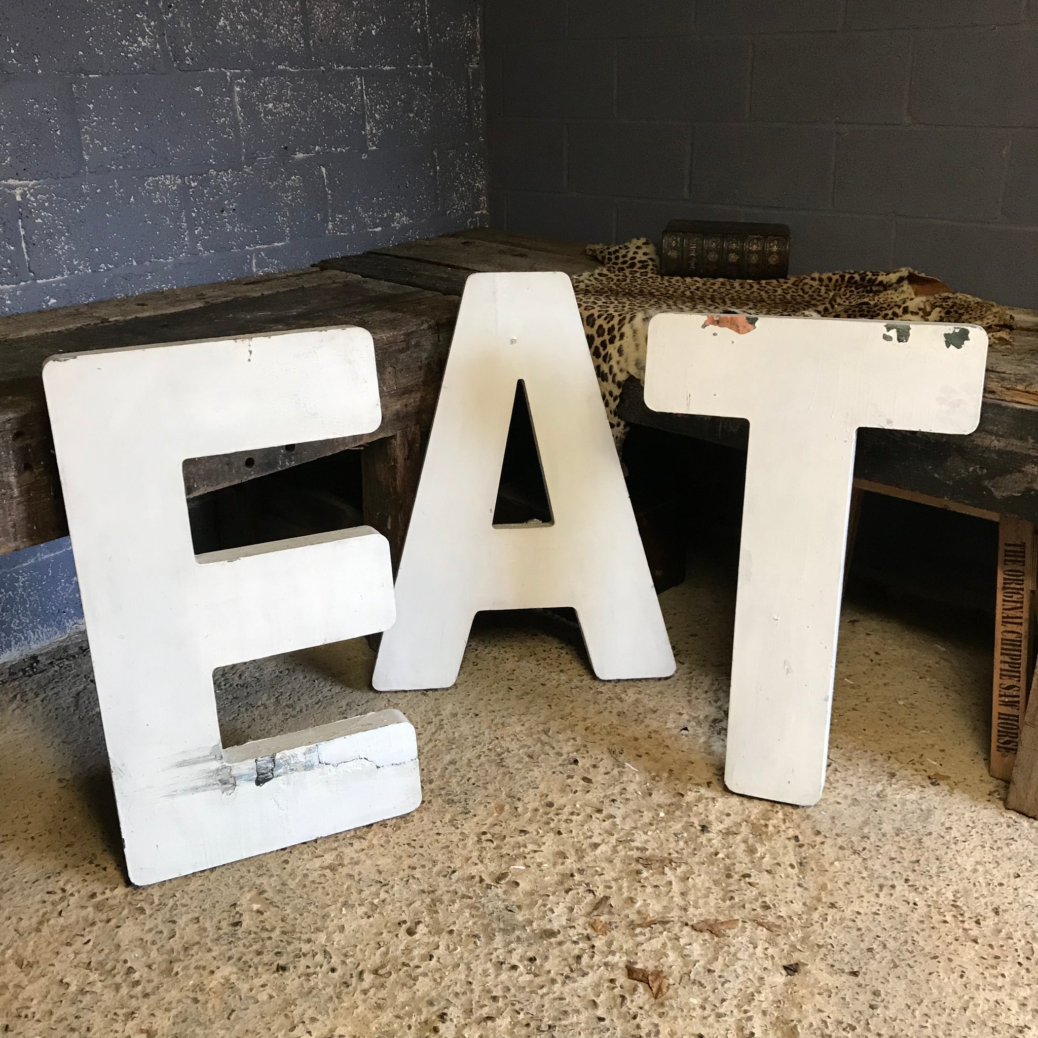 A trio of extra large wooden trade sign letters
