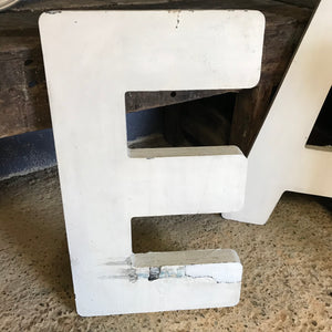A trio of extra large wooden trade sign letters
