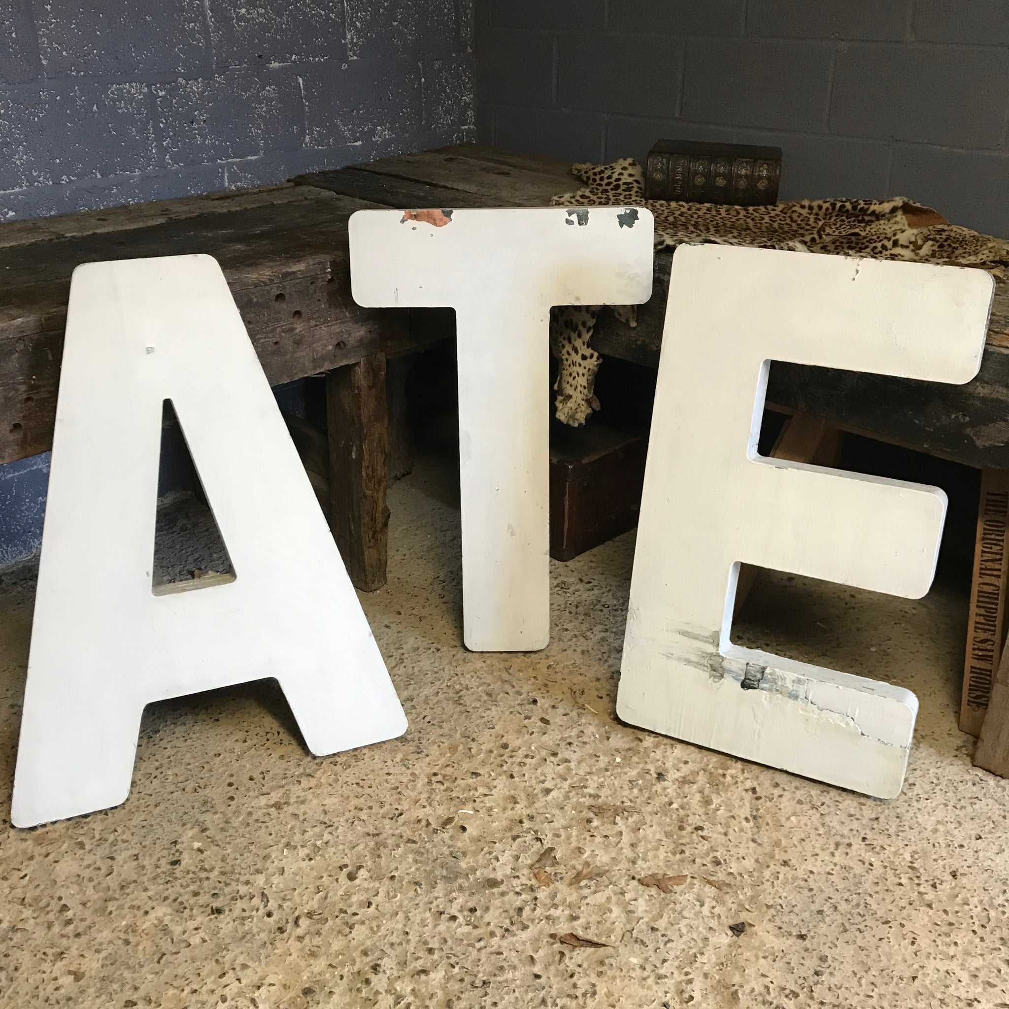 A trio of extra large wooden trade sign letters