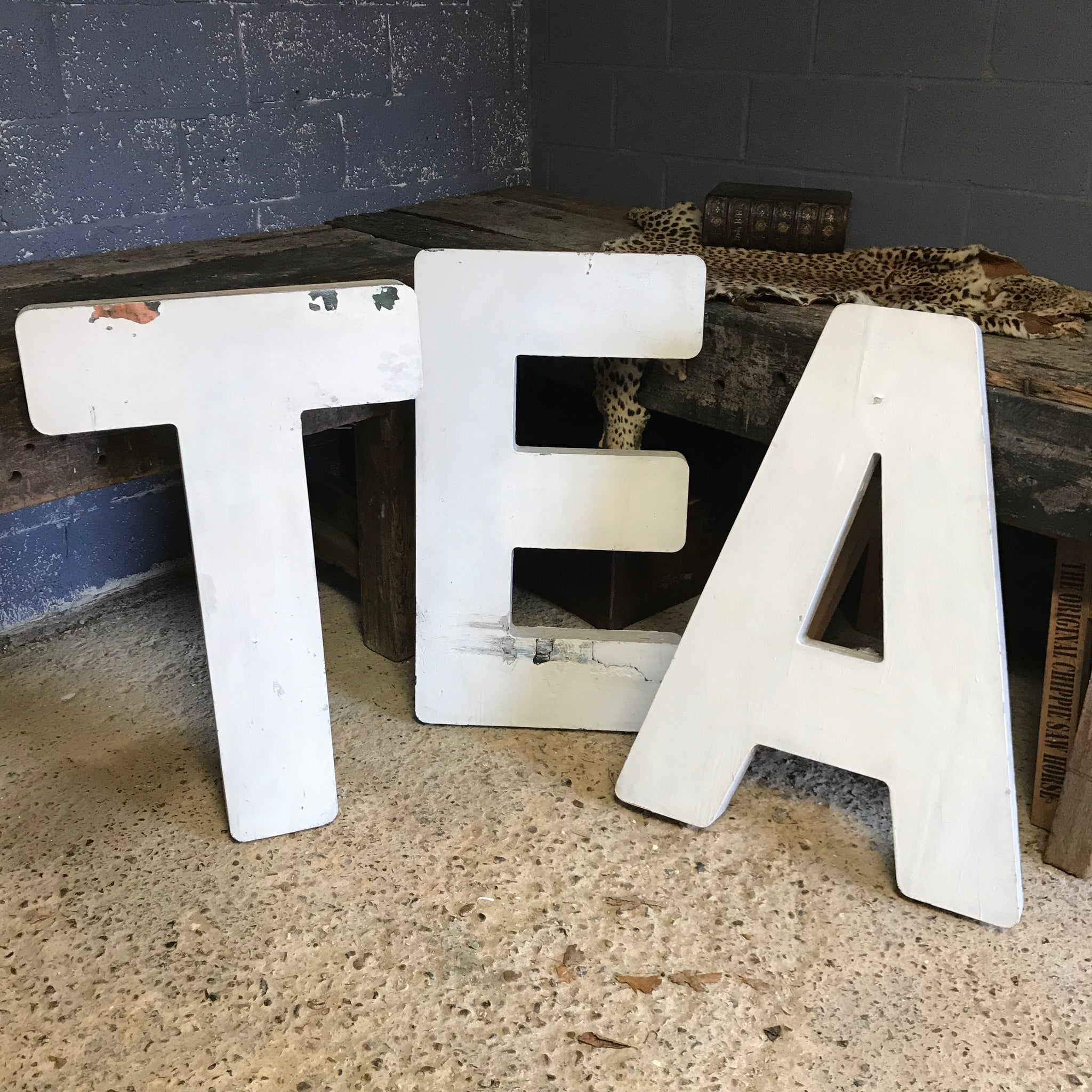 A trio of extra large wooden trade sign letters